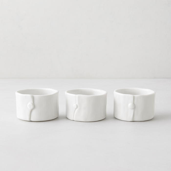 Set of 3 handmade creamy white ceramic ramequins, 3"Dia x 2"H, with organic shape and subtle vertical detail.
