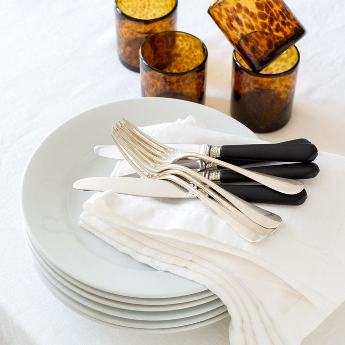 Handmade 12 oz. amber and brown tortoise double old-fashioned glasses with white plates and silverware.