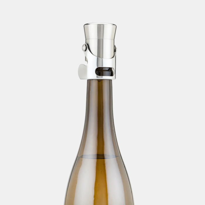 Heavyweight stainless steel champagne stopper on a brown bottle, featuring a sleek, polished silver design.