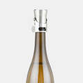 Heavyweight stainless steel champagne stopper on a brown bottle, featuring a sleek, polished silver design.