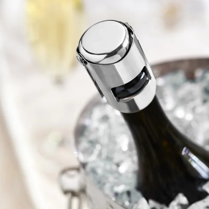 Heavyweight stainless steel champagne stopper on a bottle in an ice bucket.