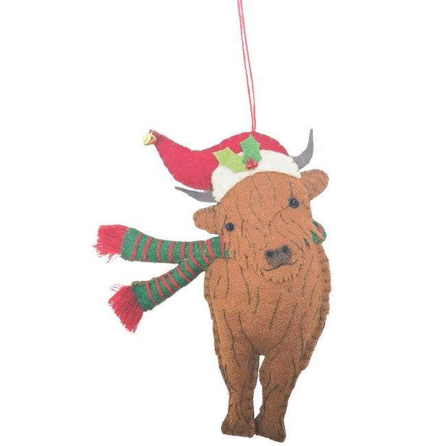 cow ornament wearing a Christmas hat and scarf