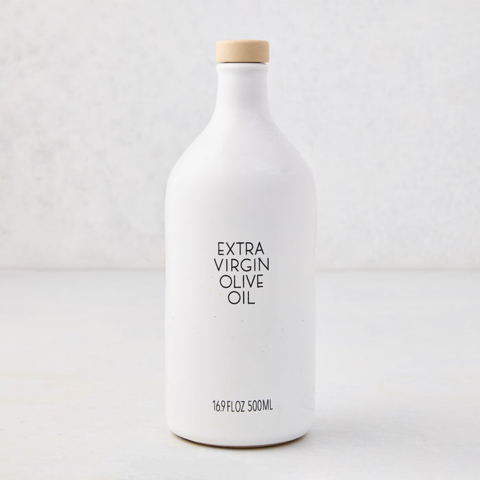 Hudson Grace Extra Virgin Olive Oil in a white ceramic bottle with a wood cork and black label.