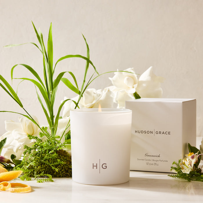 Hudson Grace Greenwich 3-Wick Scented Candle in a white glass vessel with HG logo, box, and gardenia flowers.