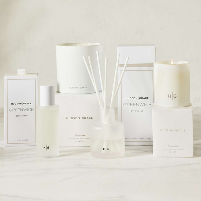 Hudson Grace Greenwich Scented Candle, diffuser, and room spray in white glass vessels and boxes.