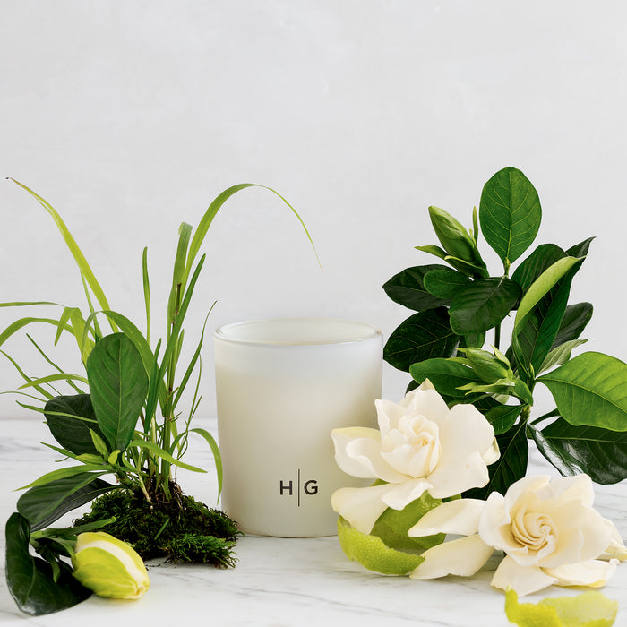 Hudson Grace Greenwich 3-wick scented candle in a white glass vessel with gardenia, grass, and lime peel.