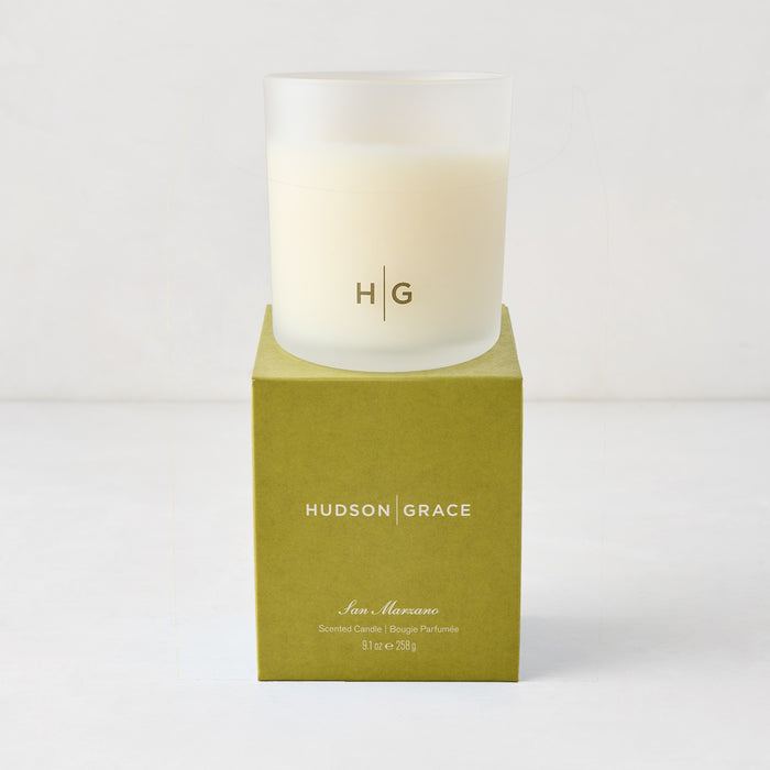 Hudson Grace San Marzano scented candle in a frosted glass vessel with HG logo, on a green box.