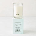 Hudson Grace Sweet Basil Kitchen Candle, white wax in clear glass, on a light teal box with black text.