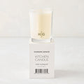 Hudson Grace Tart Kumquat Kitchen Candle in a clear glass votive with HG logo, on its white box.