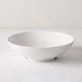 Hudson Grace white ceramic berry bowl, 9"Dia. x 2.5"H, with drainage holes, on a white surface.