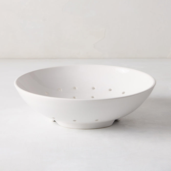 Hudson Grace white ceramic berry bowl, 9"Dia. x 2.5"H, with drainage holes, on a white surface.