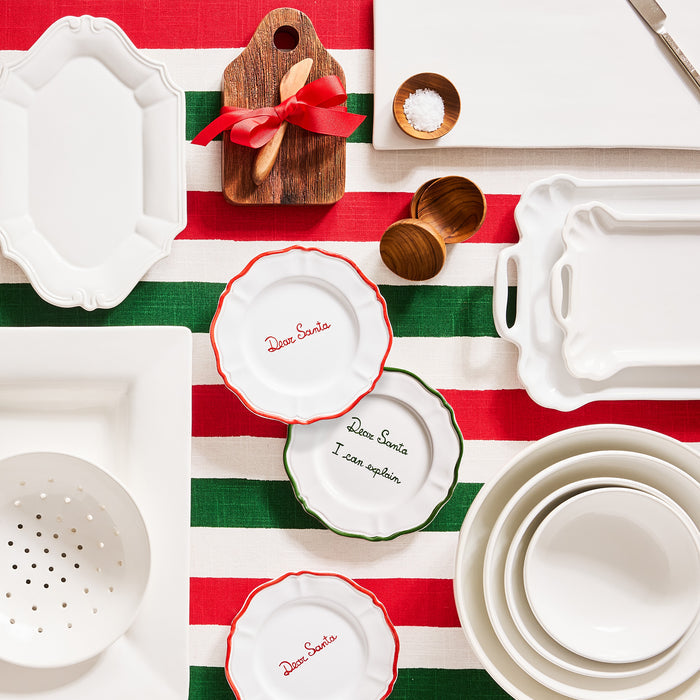 White ceramic berry bowl with colander holes, 9"Dia. x 2.5"H, on a red and green striped tablecloth.