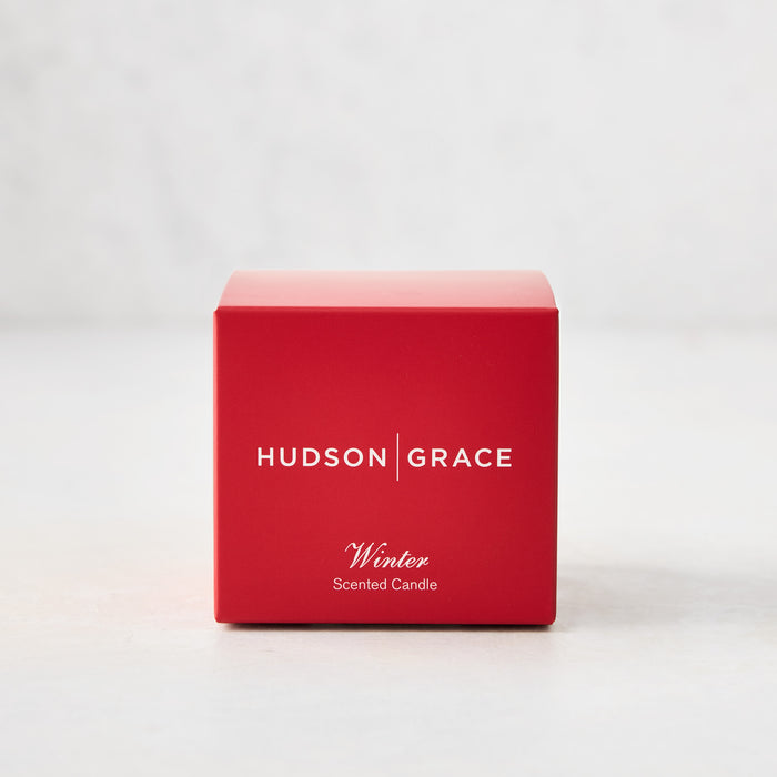 Hudson Grace Winter Scented Votive Candle in a red gift box with white text.