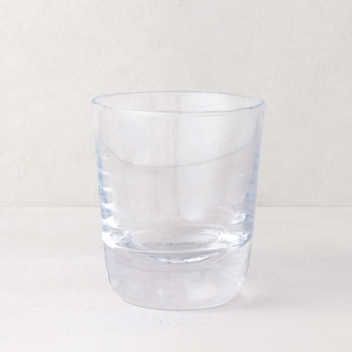 Clear, chunky Hudson Stemless Glass, 3.5"Dia x 4"H, with a thick base, on a white surface.