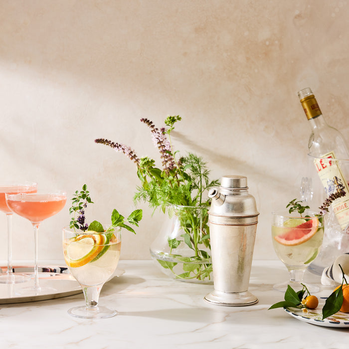 Clear Hudson Water Goblet with citrus slices and mint, part of a cocktail setup.