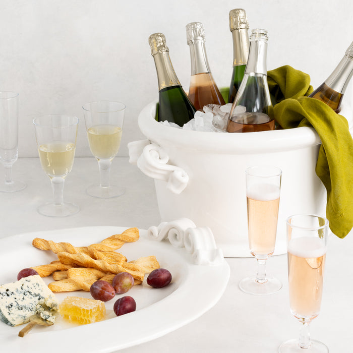 Hudson Wine Glass, clear glass, chunky style, with champagne flutes, champagne bucket, and appetizers.