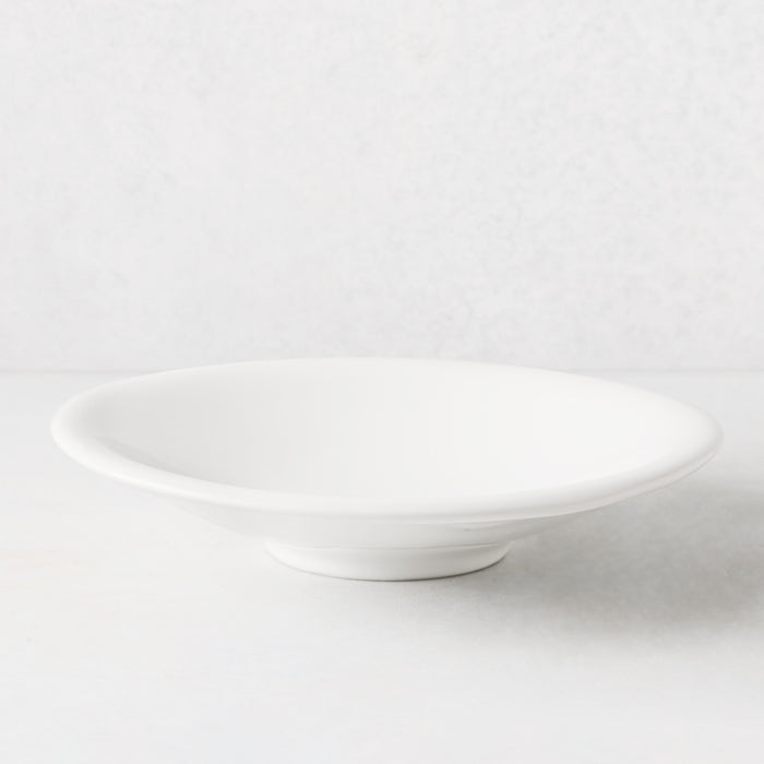 White individual ceramic pasta bowl, 10.75" diameter, shallow and wide, with a subtle footed base.
