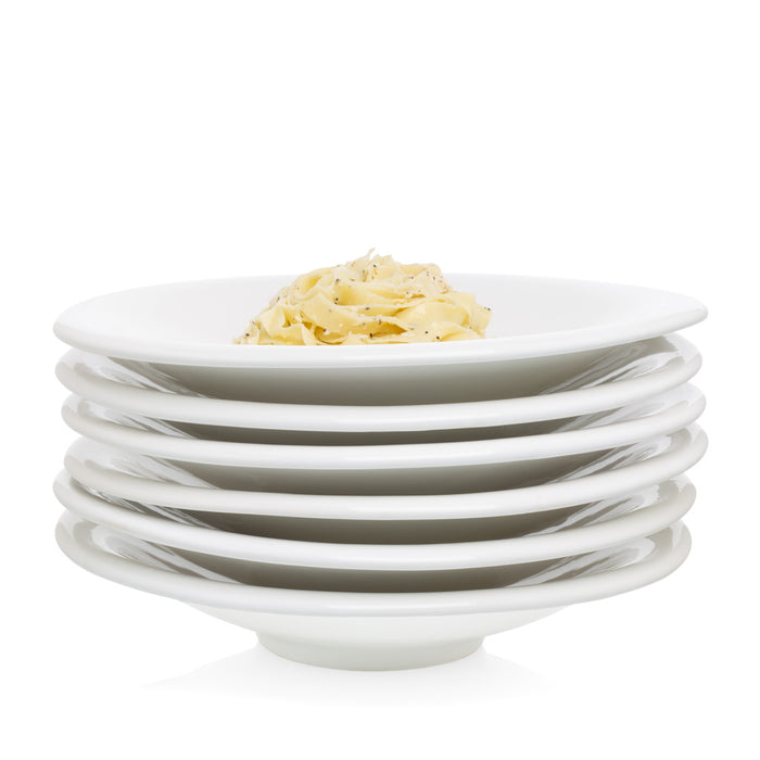 Stack of white ceramic pasta bowls, one topped with pasta.