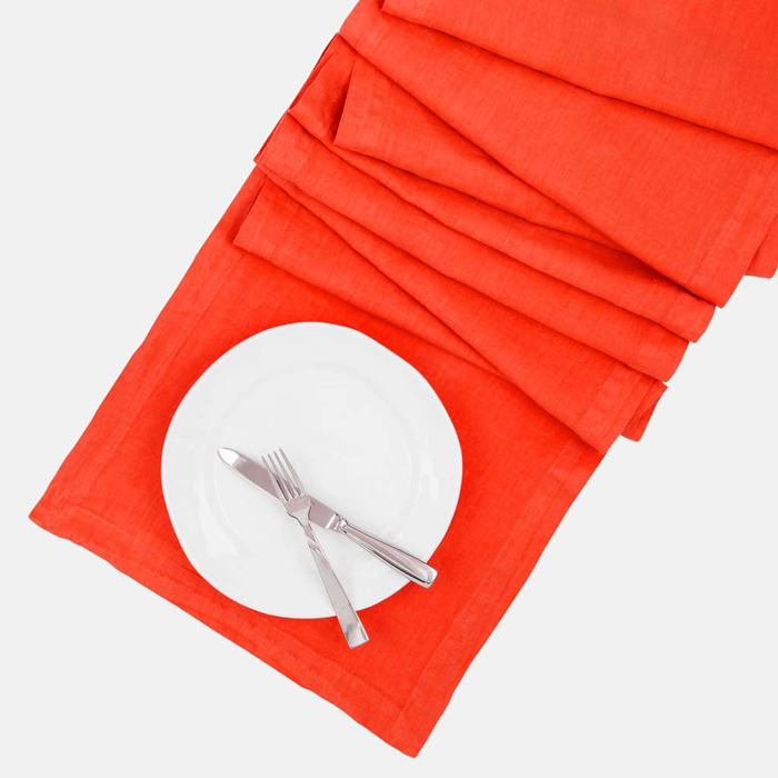 International Orange HG Signature Hand-dyed Linen Table Runner, 18" x 108", with white plate and silverware.