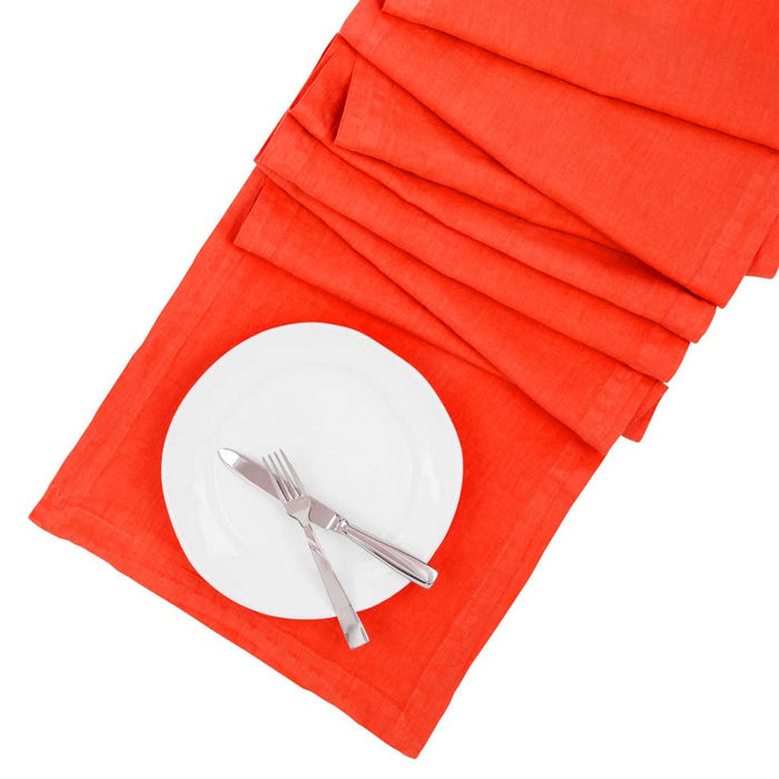 International Orange HG Signature hand-dyed linen table runner with white plate and silverware.