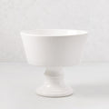Italian white ceramic compote, 9" Dia x 8" H, with a modern footed bowl design and creamy glaze.