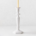 Small white Italian ceramic candlestick with intricate antique-style detailing and a taper candle.