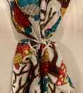 A scarf ring with crystal embellishments shown here with a multicolored scarf (sold separately).