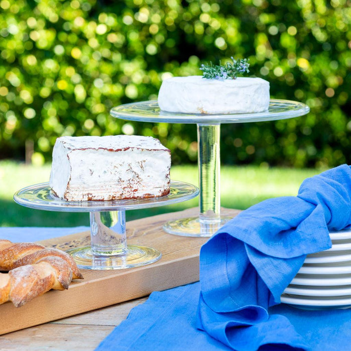 Klara Large High Clear glass cake stand, 12"Dia x 7.5"H, displaying white cakes outdoors.