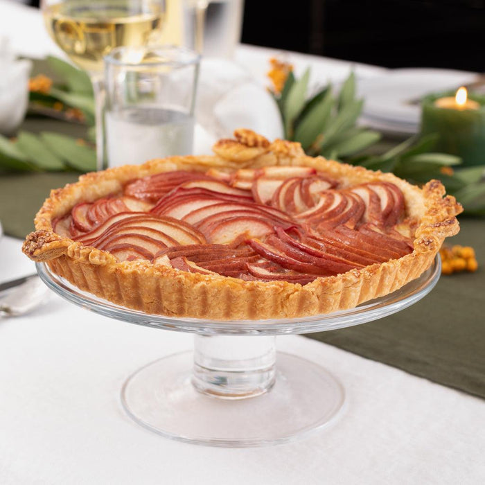 Clear glass Klara Small Cake Stand, 9.5"Dia. x 4"H, holding a pear tart on a dining table.