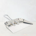Large, flat-lying aluminum dust pan with a silver handle, designed for hands-free use.