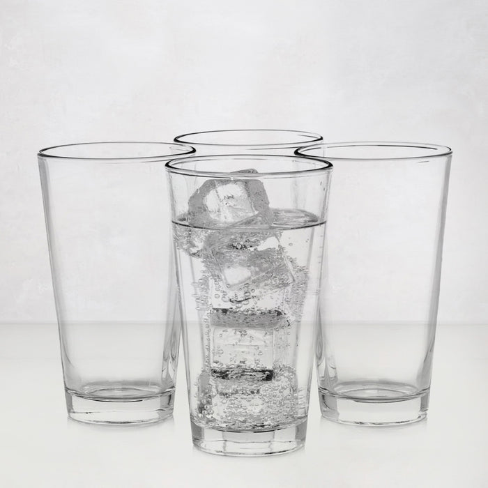 Four clear, tall Hudson Grace drinking glasses; one filled with water and ice.