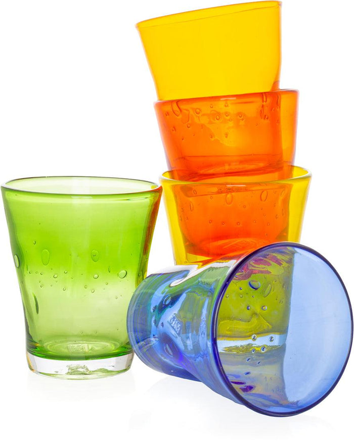 Stack of colorful Henri mouth-blown glass tumblers in yellow, orange, green, and blue with air bubbles.
