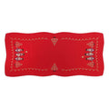 Red linen table runner with embroidered Christmas carolers and gold decorative accents