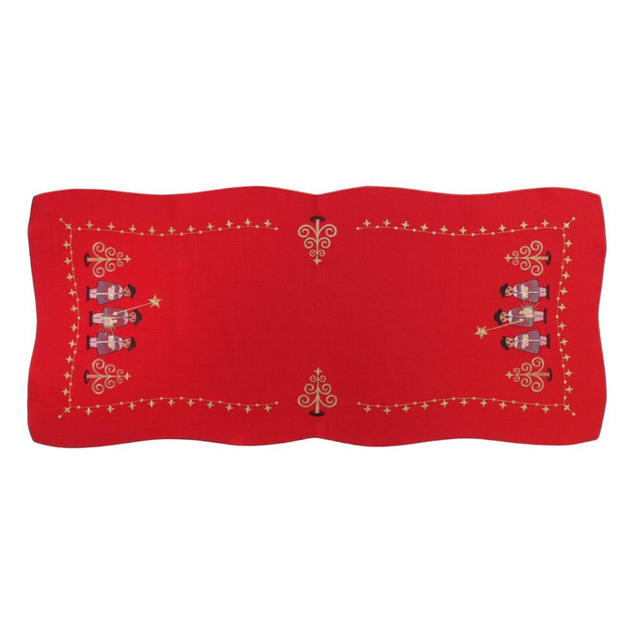 Red linen table runner with embroidered Christmas carolers and gold decorative accents