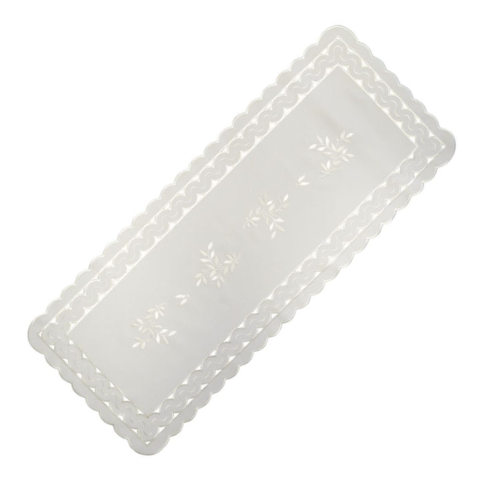 White linen table runner with scalloped cutwork edges and subtle leaf tendril embroidery, large size