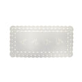White linen table runner with scalloped cutwork edges and subtle leaf tendril embroidery