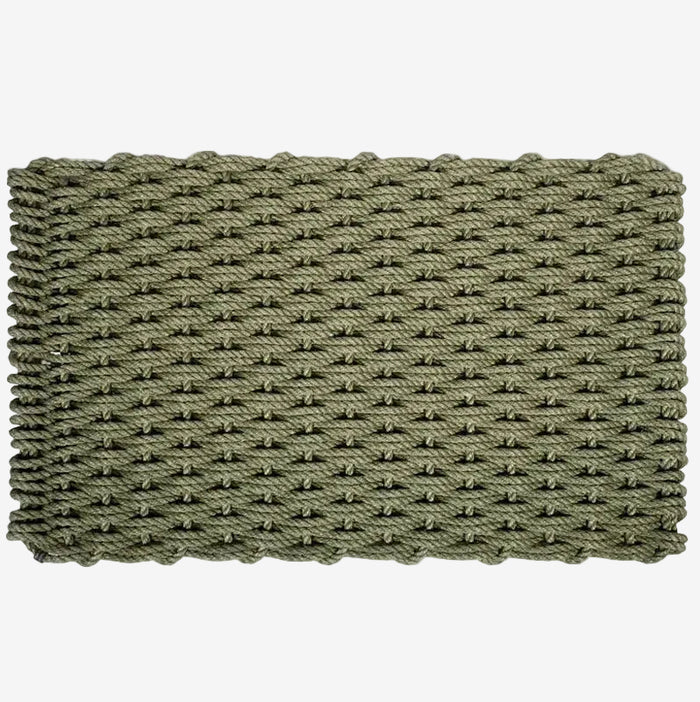 Loden green handwoven rope doormat with a tight, textured weave and braided edges.