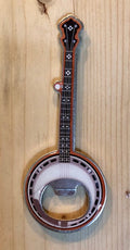 Magnetic metal bottle opener in the shape of a banjo with intricate detail on front.