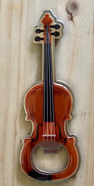 A metal bottle opener shaped like a fiddle with a white squirrel and the text 'Brevard, NC' on the back. Front
