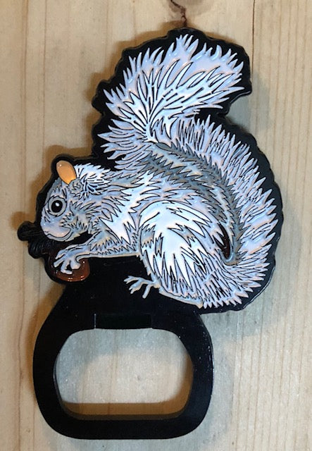 Magnetic metal bottle opener in the shape of a white squirrel holding a nut.