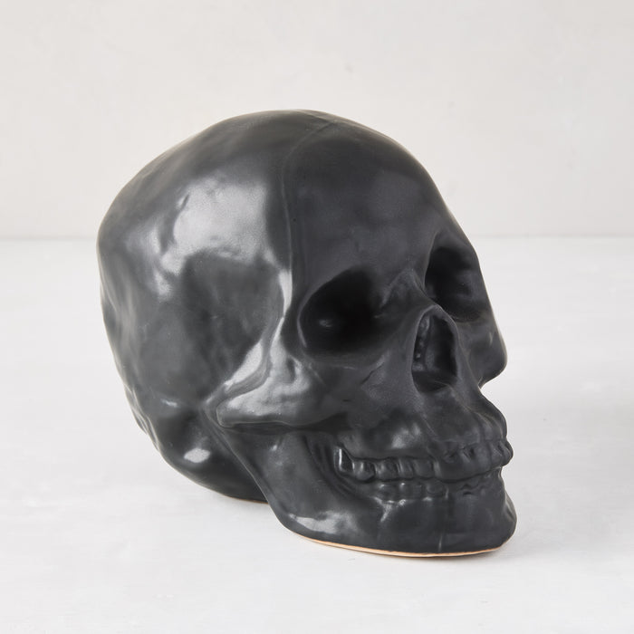 Matte black ceramic Halloween skull, 5.5"H x 7"W, with realistic details.