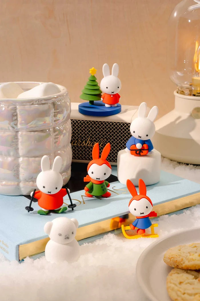 Miffy in the Snow Blind Box Figure diorama with Miffy skiing, sledding, gifting, and beside a Christmas tree, set on faux snow with Snowman Borris.