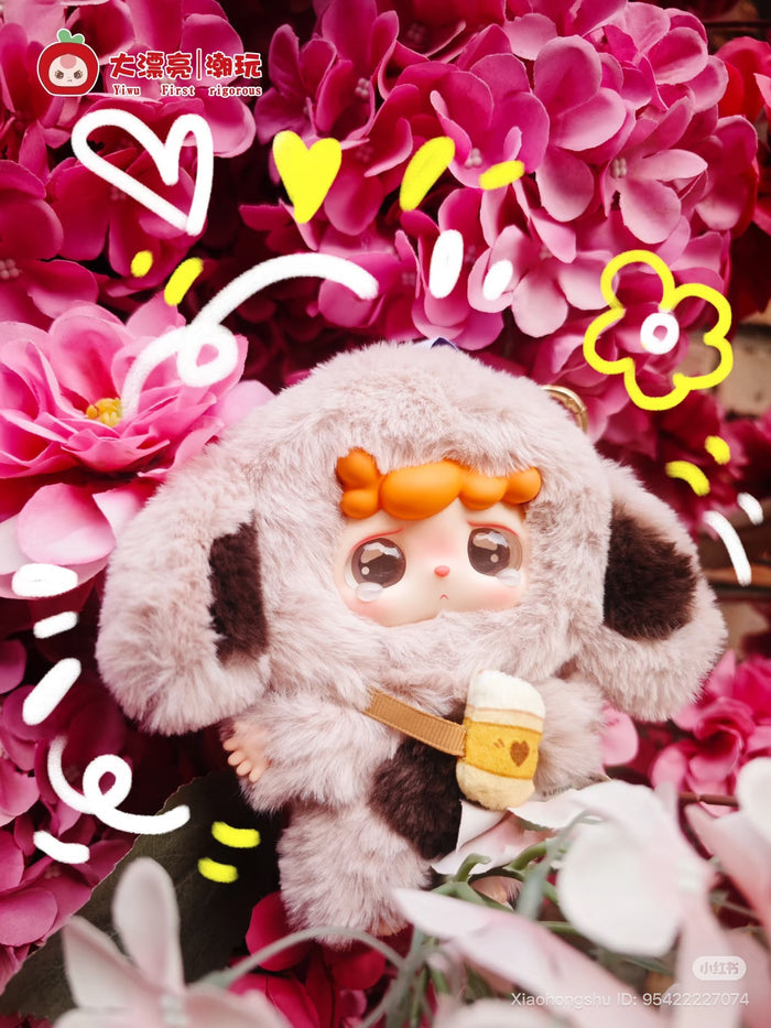 Mitutu and Hulala Series Plush Keychain Blind Box featuring a doll in a fluffy costume with floppy ears and a tiny felted pouch, surrounded by playful doodles.