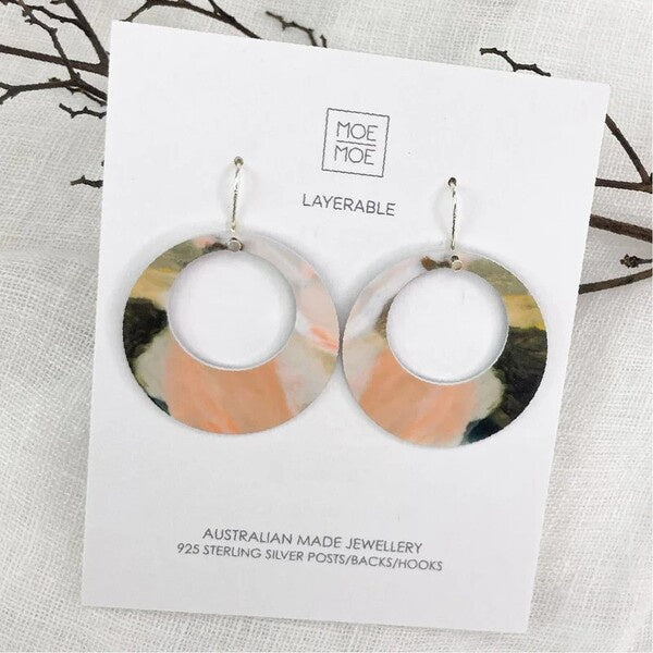 Pair of layered earrings on a Moe Moe branded card