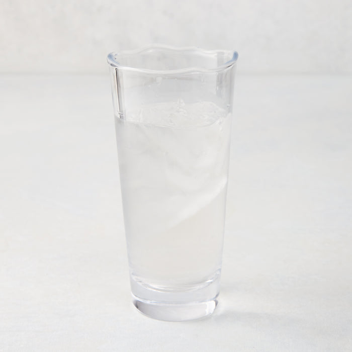Mozes Scissor-Cut Water Glass, clear air-blown glass, 10.5 oz, with a rippled rim, filled with ice water.