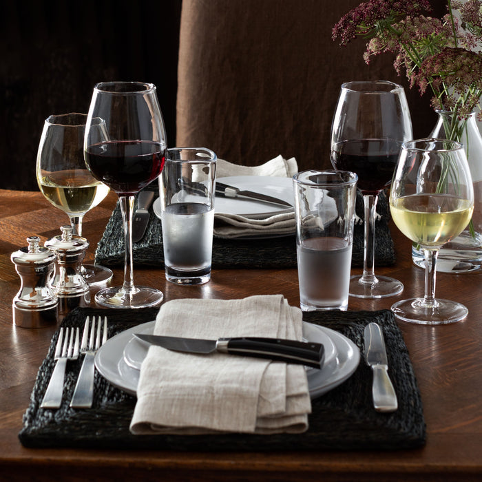 Mozes Scissor-Cut Water Glass, clear air-blown glass, 10.5 oz, on a set dining table.