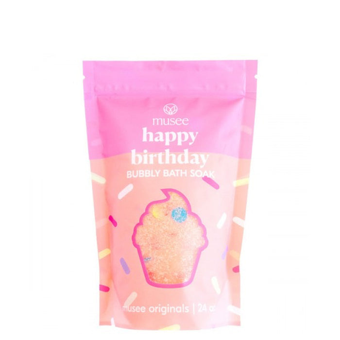 Pink packaging of Musee Bath Happy Birthday Bubbly Bath Soak with a cupcake illustration and sprinkles.