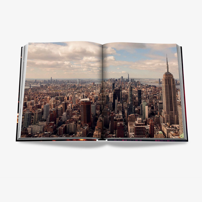 Open "New York Chic" silk hardcover book displaying a vibrant aerial photo of the NYC skyline.