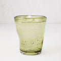 Olive Henri 8 oz. mouth-blown glass with ice, showing unique imperfections and small air bubbles.