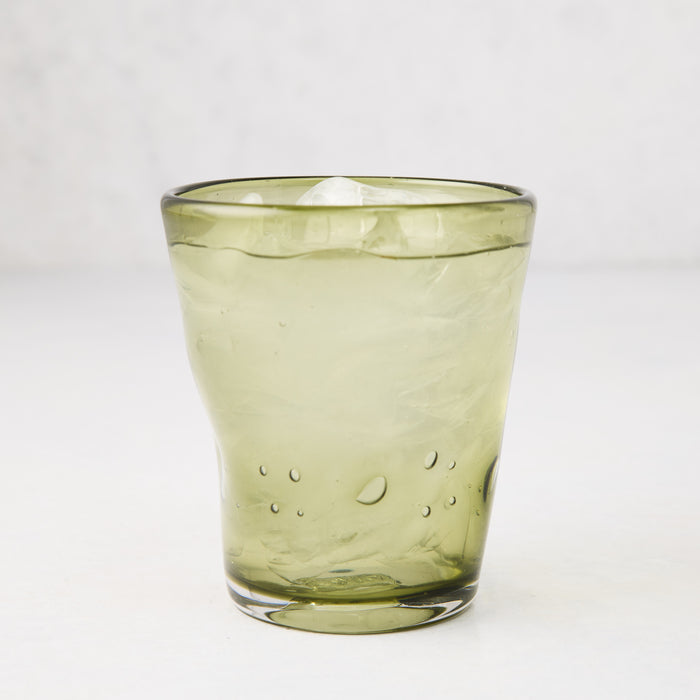 Olive Henri 8 oz. mouth-blown glass with ice, showing unique imperfections and small air bubbles.